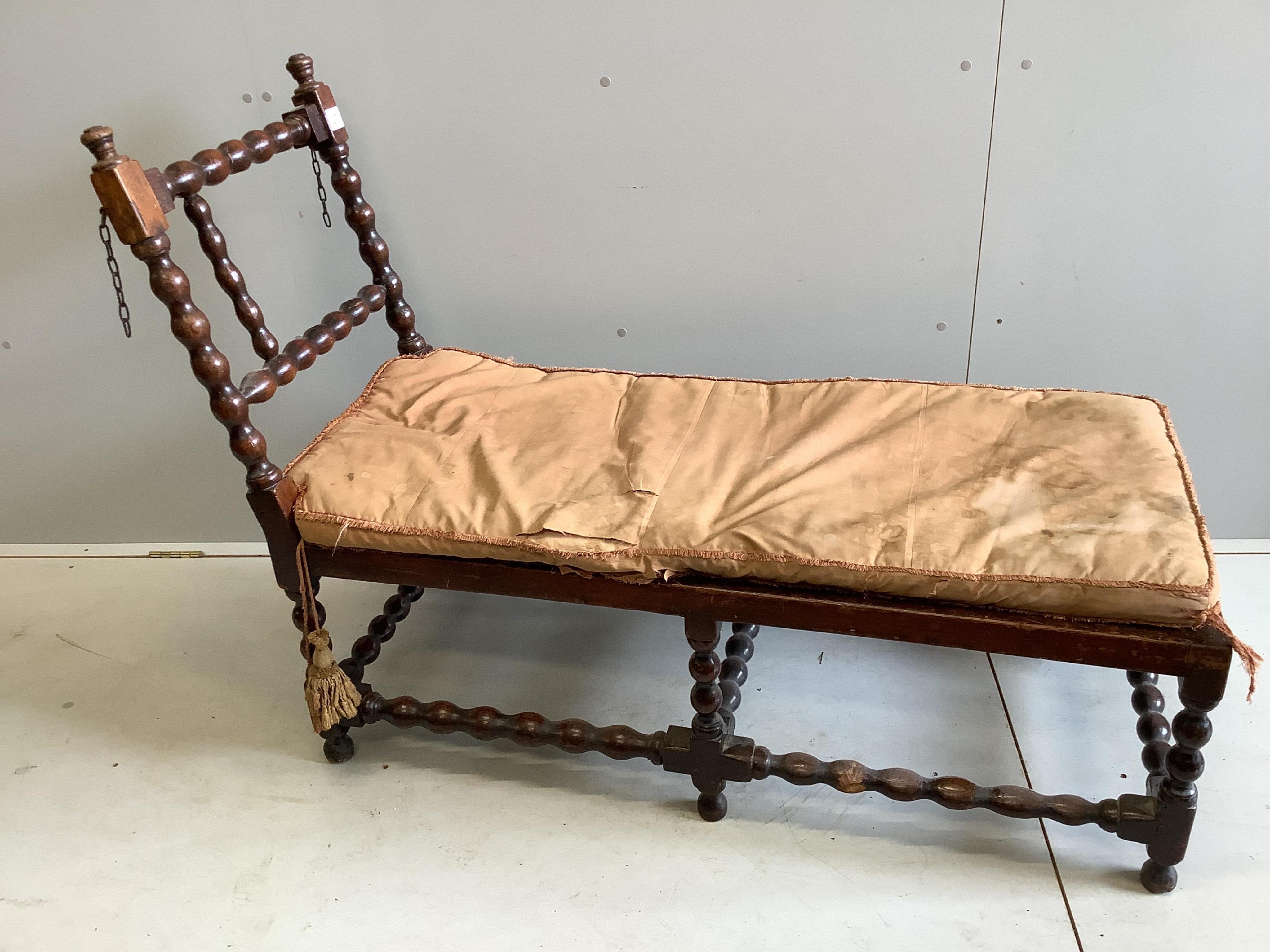 An early 20th century oak frame daybed, width 131cm, depth 53cm, height 97cm. Condition - poor